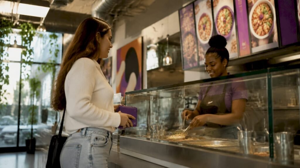 Customer ordering at fast-casual restaurant counter