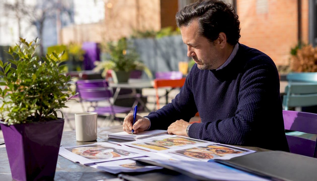 Man reading burrito chain article at kitchen table