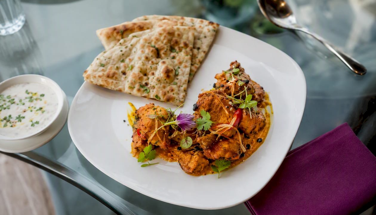 Plated authentic Indian meal with fresh bread