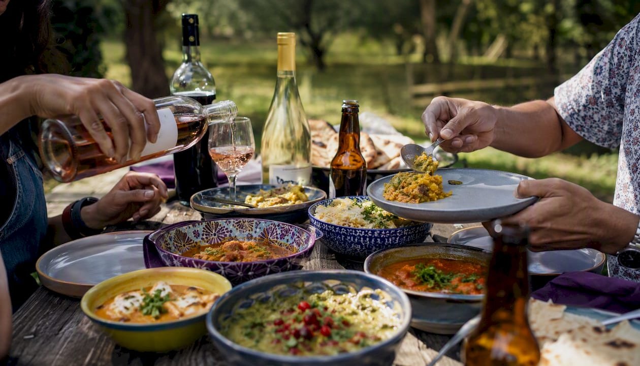 BYOB dining table with Indian food and drinks