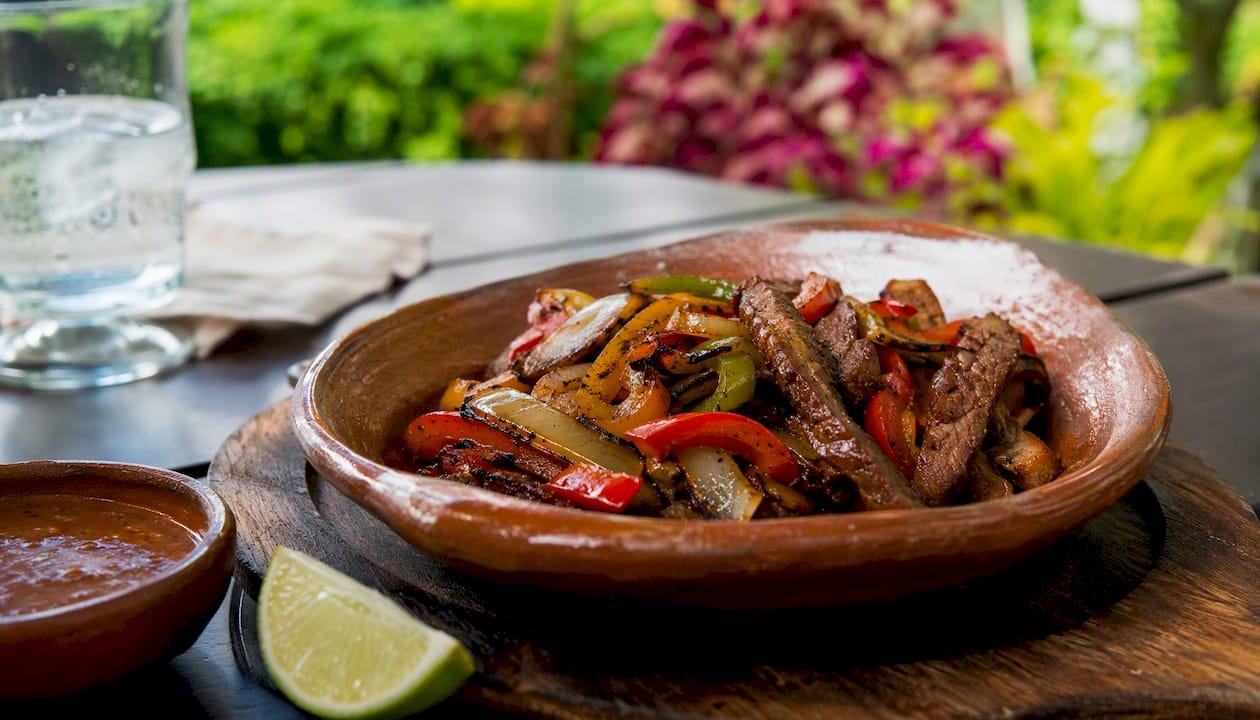 Grilled steak fajitas with peppers and onions