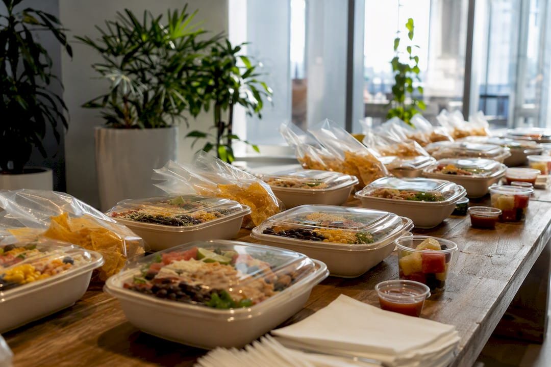 Individually packaged burrito bowls on catering table