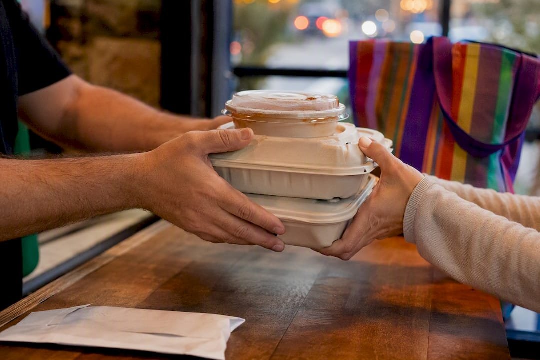Handing over Mexican food takeout order