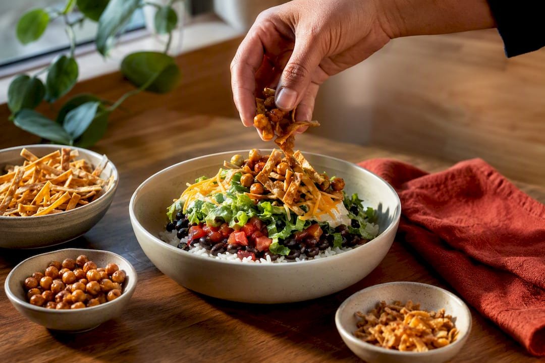 Adding crunchy toppings to vegetarian bowl