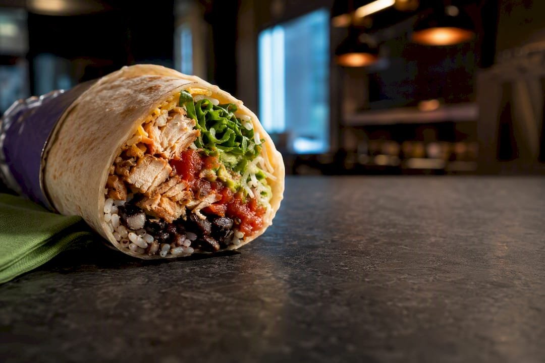 Partial burrito revealing layered ingredients