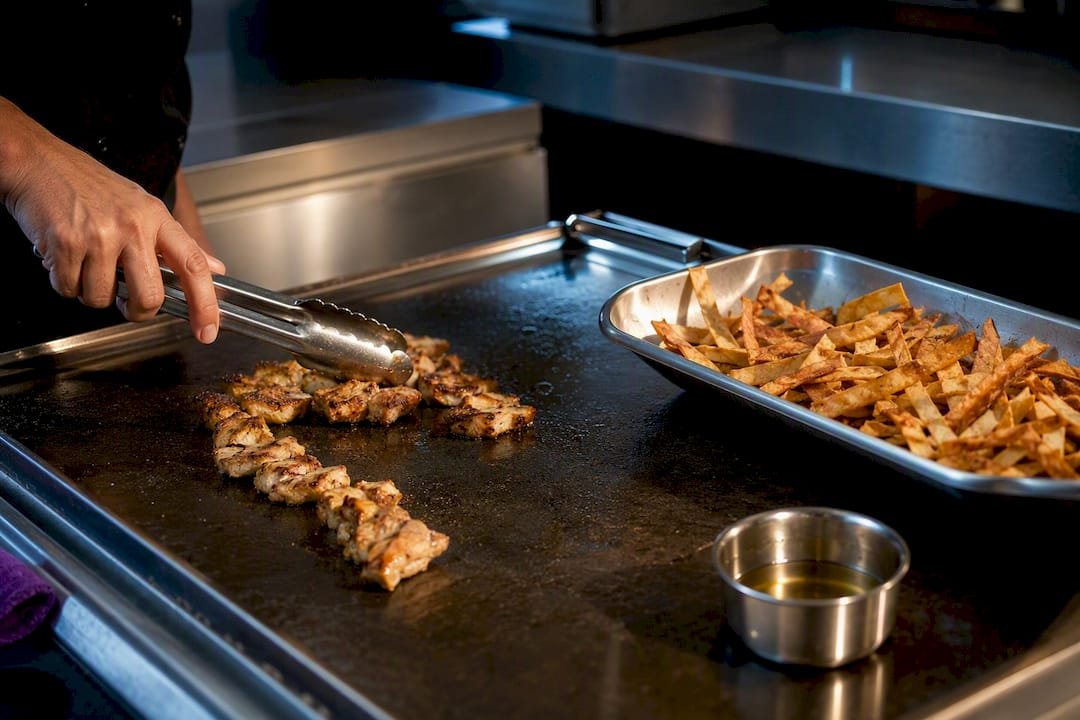 Grilled protein beside fried tortilla strips